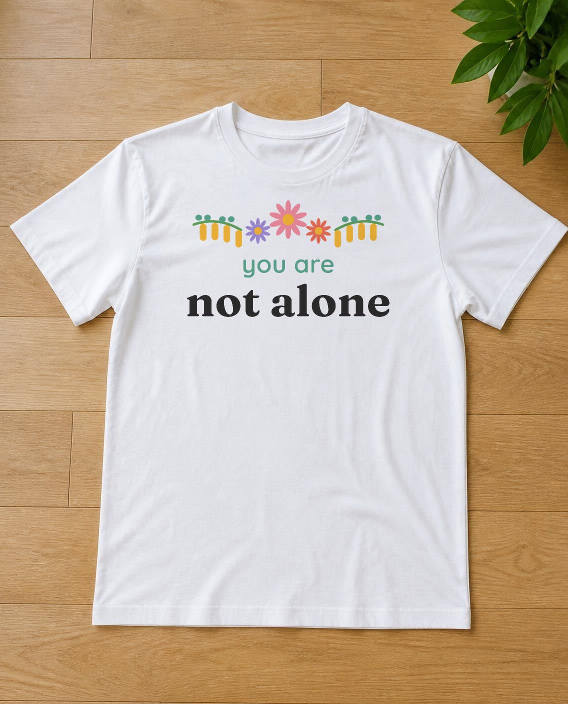 You are not alone design on a white tee